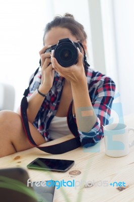 Young Woman Photographer Taking A Photography In The Studio Stock Photo