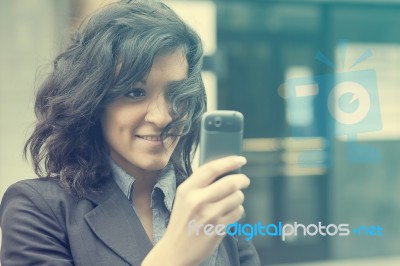 Young Woman Photographing With Cell Phone Stock Photo