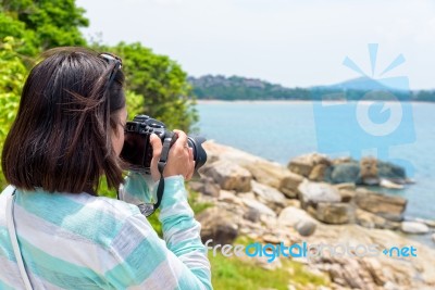 Young Woman Photography Near The Sea Stock Photo