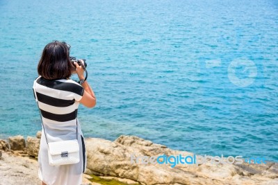 Young Woman Photography Near The Sea Stock Photo