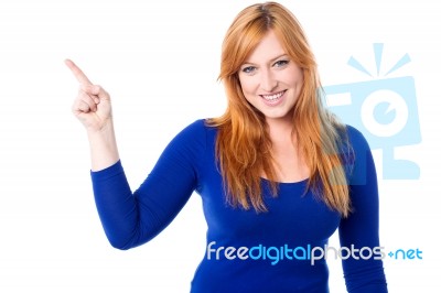 Young Woman Pointing Away Over White Stock Photo