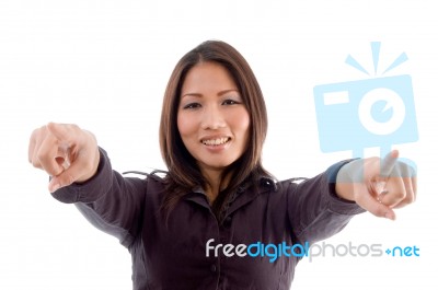 Young Woman Pointing With Both Hands Stock Photo