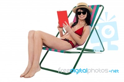 Young Woman Reading Book And Relaxing Stock Photo