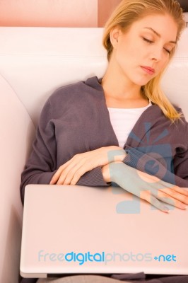 Young Woman Resting Sofa While Using Laptop Stock Photo