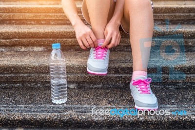 Young Woman Runner Tying Shoelaces. Exercise Concept Stock Photo