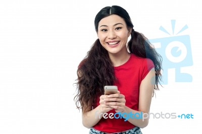 Young Woman Sending A Text Message Stock Photo