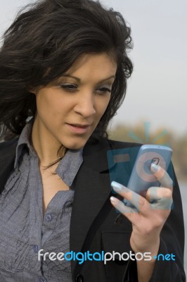 Young Woman Sends A Text Message Stock Photo