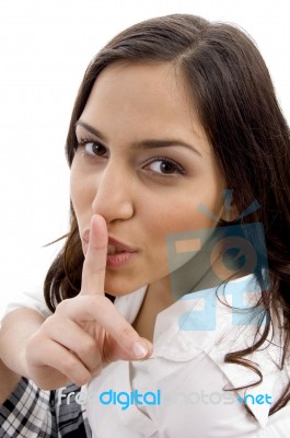 Young Woman Shushing With Hand Gesture Stock Photo