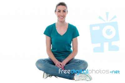 Young Woman Sitting On The Floor Stock Photo