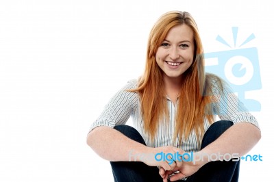 Young Woman Sitting On The Floor Stock Photo