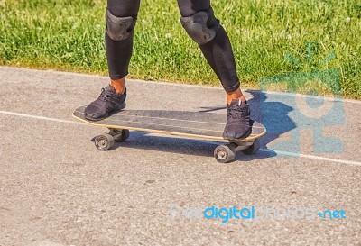 Young Woman Skateboarding In The Park Stock Photo