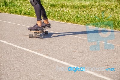 Young Woman Skateboarding In The Park Stock Photo