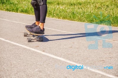 Young Woman Skateboarding In The Park Stock Photo