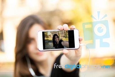 Young  Woman Taking A Photo With Her Phone Stock Photo