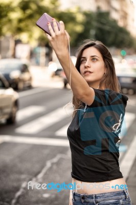 Young  Woman Taking A Photo With Her Phone Stock Photo