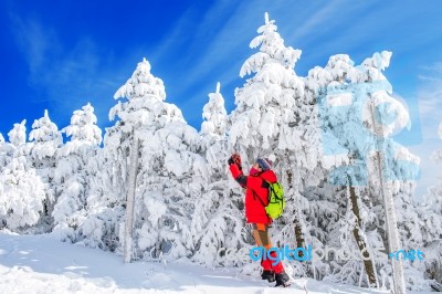 Young Woman Taking Photo With Smartphone On Mountains In Winter Stock Photo