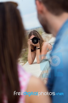 Young Woman Taking Pictures Of A Couple In The City Stock Photo