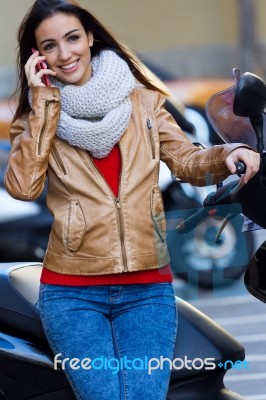 Young Woman Talking On Mobile In The City Stock Photo