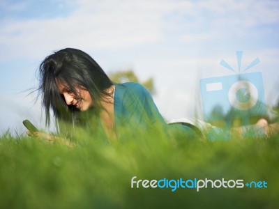 Young Woman Using Laptop In Park Stock Photo