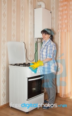 Young Woman Washes A Gas Stove Stock Photo