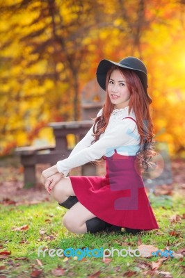 Young Woman With Autumn Leaves In Maple Garden Stock Photo