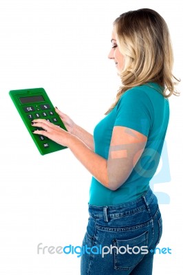 Young Woman With Calculator Stock Photo