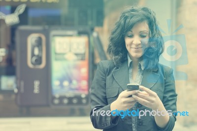 Young Woman With Cell Phone Walking Stock Photo