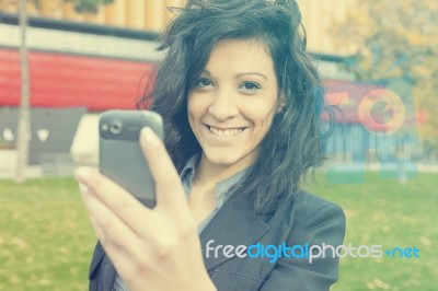 Young Woman With Cell Phone Walking Stock Photo