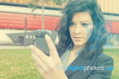 Young Woman With Cell Phone Walking Stock Photo