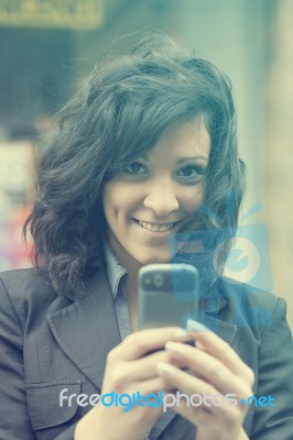 Young Woman With Cell Phone Walking Stock Photo