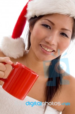 Young Woman With Christmas Hat Holding Coffee Mug Stock Photo