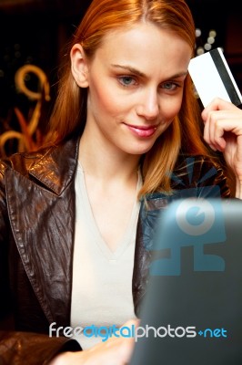 Young Woman With Credit Card And Laptop Stock Photo