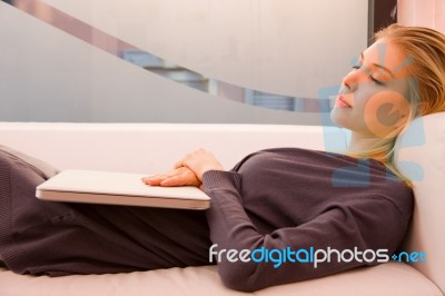 Young Woman With Laptop Sleeping Couch Stock Photo