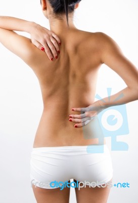 Young Woman With Pain In Her Back Stock Photo