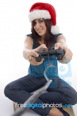 Young Woman With Remote And Christmas Hat Stock Photo