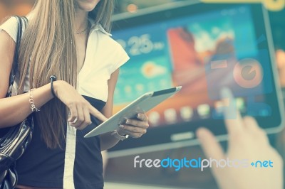 Young Woman With Tablet Computer Walking On Street Stock Photo