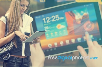 Young Woman With Tablet Computer Walking On Street Stock Photo