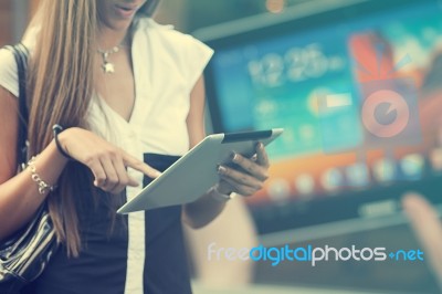 Young Woman With Tablet Computer Walking On Street Stock Photo