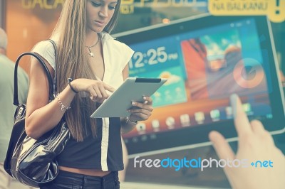 Young Woman With Tablet Computer Walking On Street Stock Photo