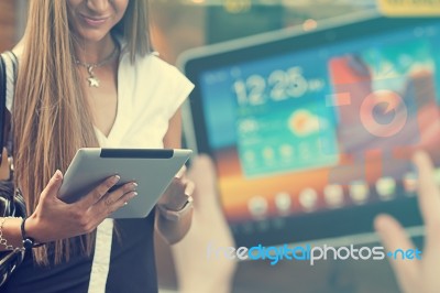 Young Woman With Tablet Computer Walking On Street Stock Photo