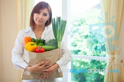 Young Woman With Vegetables In Shopping Bag Stock Photo