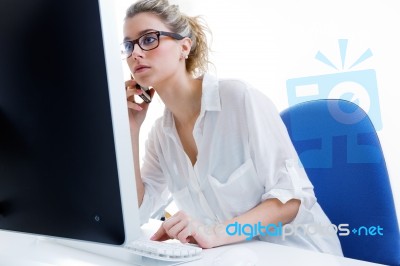 Young Woman Working From Home On The Computer And Talking On The… Stock Photo