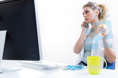 Young Woman Working From Home On The Computer And Talking On The… Stock Photo