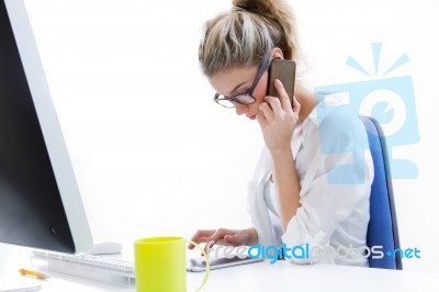 Young Woman Working From Home On The Computer And Talking On The… Stock Photo