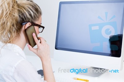 Young Woman Working From Home On The Computer And Talking On The… Stock Photo