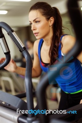 Young Woman Working Out On A Stepper Stock Photo