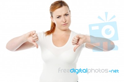 Young Women Showing Thumbs Down Stock Photo