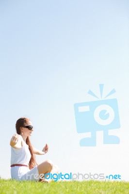 Young Women Sitting And Doing Meditating Stock Photo