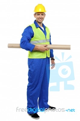 Young Worker Holding Blueprint Stock Photo