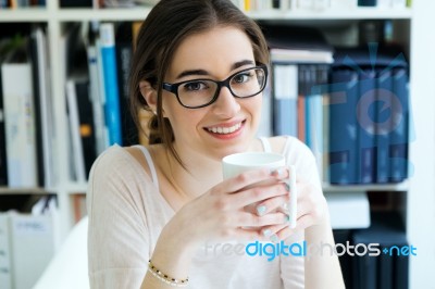 Young Worker Woman Having Coffee In Her Office Stock Photo